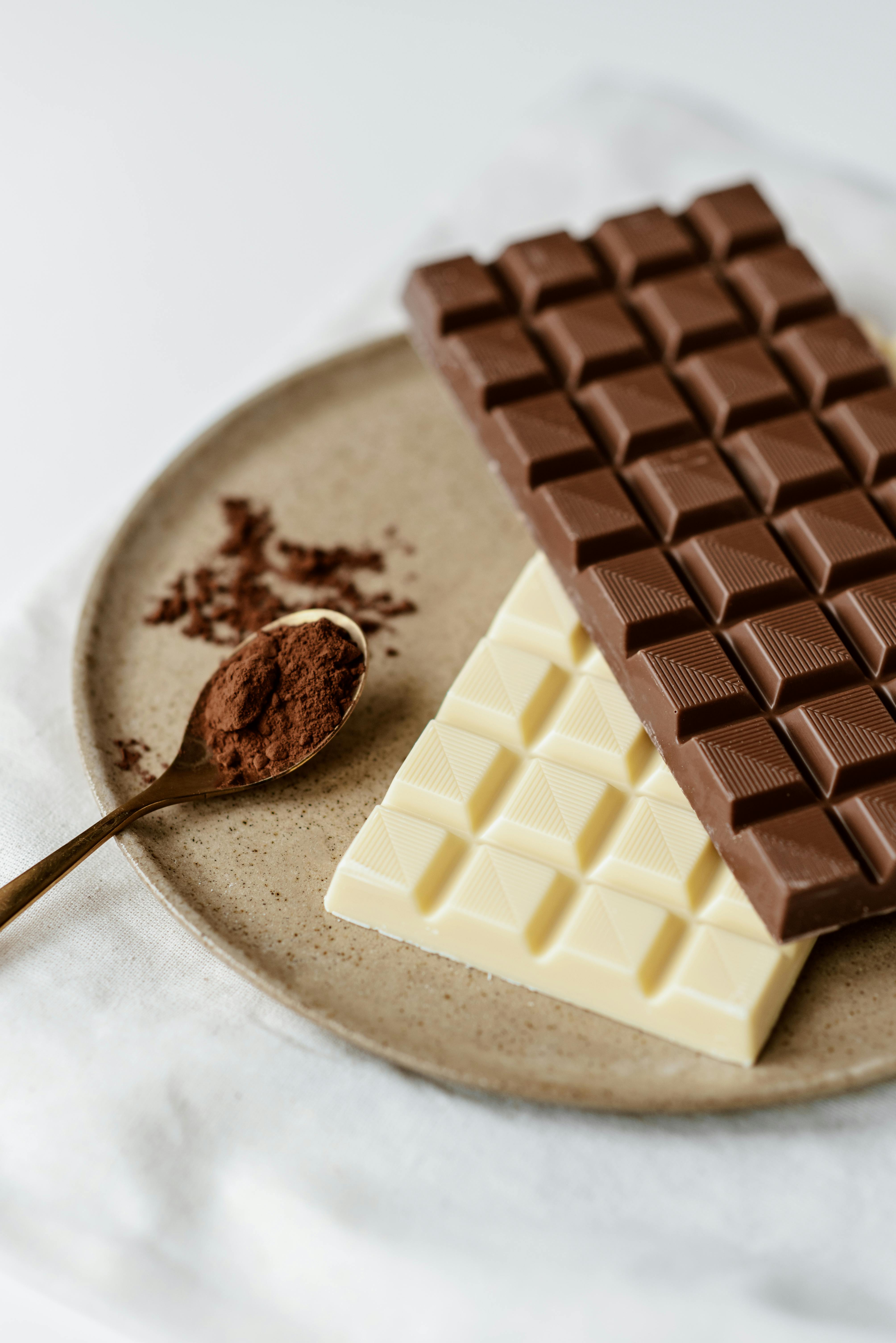 Milk and white chocolates with cocoa powder